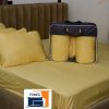 A cream colour bedsheet, duvet and four pillows.