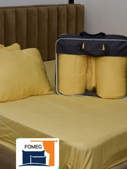 A cream colour bedsheet, duvet and four pillows.
